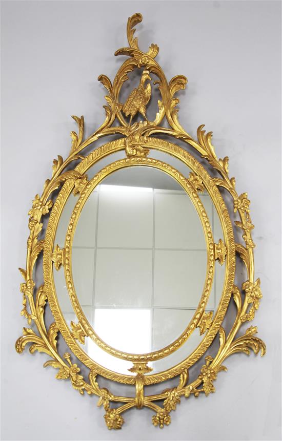 A Victorian oval gilt wall mirror, 4ft 11in. x 2ft 9.5in.